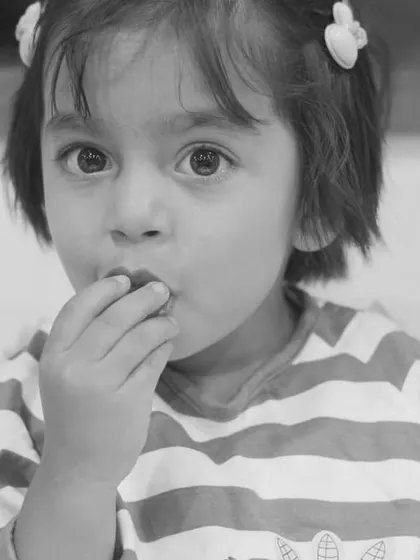 A good color picture is often a good black and white one too. This candid monochrome shot of a toddler eating focuses on the moment and the child's sweet expression.