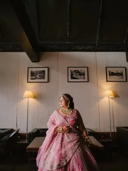 A wide shot of the bride in a modern, stylishly decorated room, giving a sense of place and atmosphere to the bridal portrait.