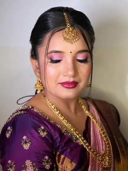 A close-up of the bridesmaid's eye makeup. The shimmery pink eyeshadow adds a touch of glamour without being too overpowering.