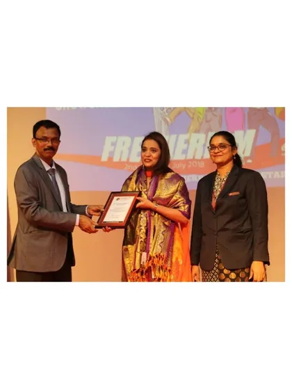 Receiving a framed certificate on stage. Every award is not just a trophy, but a symbol of the lives I've been able to touch and the positive impact I've strived to make.