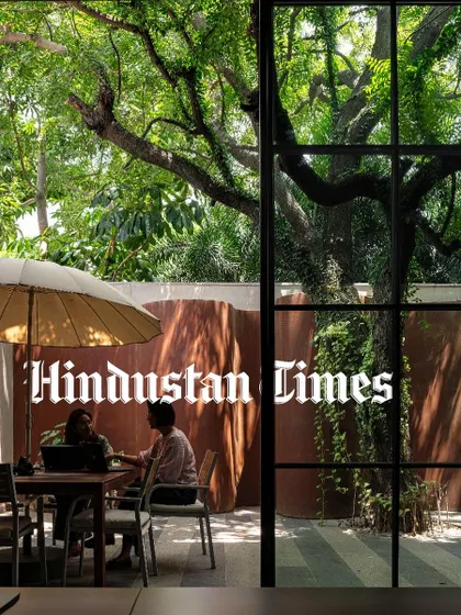 A feature in Hindustan Times discussing biophilic design, showcasing the courtyard at KEUS where employees can work or relax under a large tree, surrounded by nature.