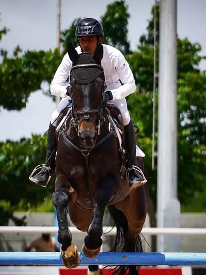 A powerful action shot of Ashish Limaye and Jinx mid-flight during their winning Grand Prix round. This image perfectly captures the athleticism and focus required for top-level show jumping.