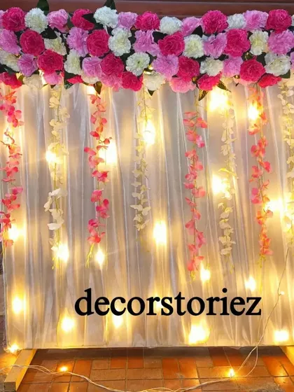 A closer look at our pre-lit Ganpati backdrop. The warm lights create a beautiful ambiance, while the floral arrangement on top adds a touch of elegance. This setup is designed for easy installation at home.
