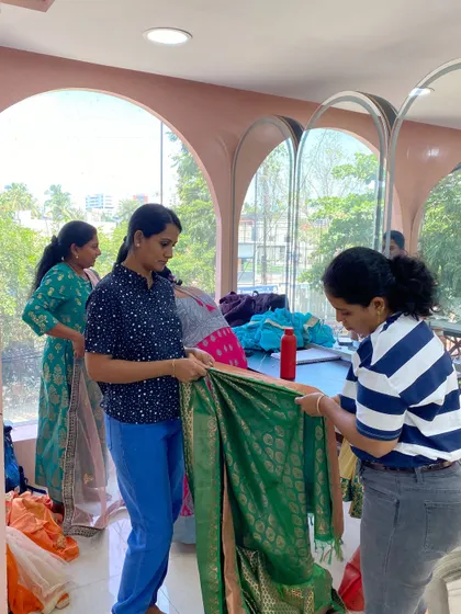 Teamwork during our saree draping session. Students help each other get the pleats just right, learning from one another in the process.
