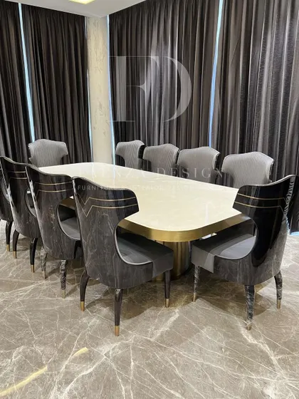 We believe the dining room is for making memories. This grand 10-seater dining set, featuring a polished onyx tabletop and uniquely designed chairs with gold accents, is crafted to be the centerpiece of your home's hospitality.
