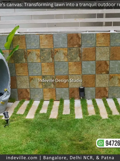 A pathway made of stone slabs set into the lawn, leading past a tiled wall. This hardscaping element provides a functional path while adding to the garden's aesthetic.