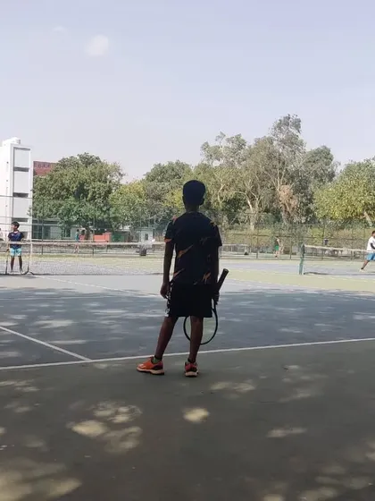 A young player prepares for his match during the TPL-ITA tournament. This image shows the on-court environment at our venue, where players compete on well-maintained hard courts.