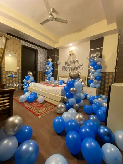A different angle of the blue and silver birthday room, showing the extent of the balloon decorations.