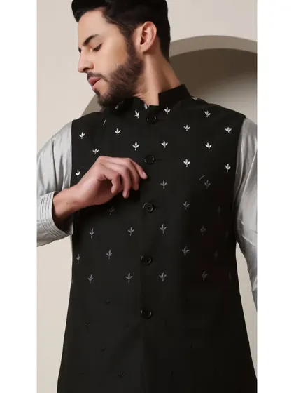 A close-up of the 'Shoorveer' black Bandi jacket. This shot focuses on the subtle, scattered silver embroidery, a detail that adds a touch of luxury without being overpowering.