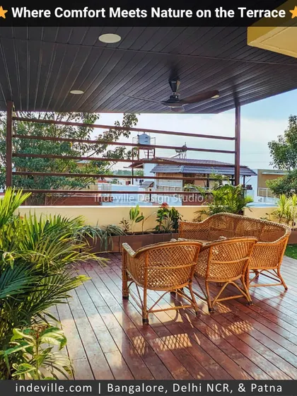 This view showcases the shaded seating area on a redesigned terrace. I used natural cane furniture on a raised wooden deck, surrounded by planters, to create an inviting space for relaxation.
