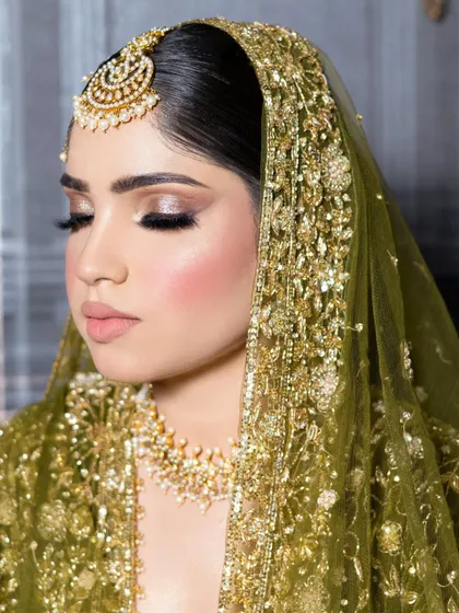 The complete bridal look with a beautiful olive green dupatta. The makeup is designed to be long-lasting and picture-perfect from every angle.