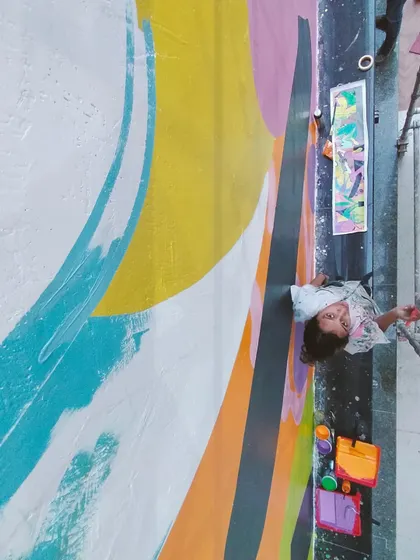 A top-down view of me painting, showing the vibrant color palette of this abstract corporate piece.