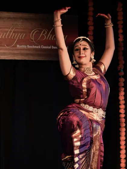A beautiful pose under the 'Nruthya Bhanu' banner at Kappanna Angala.