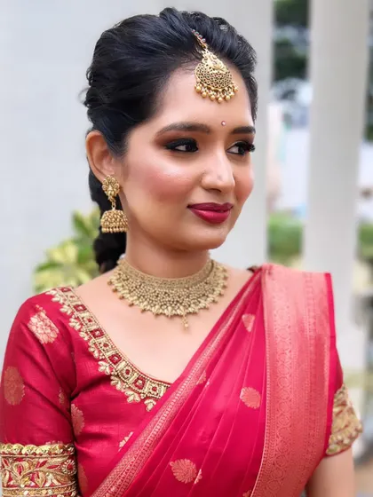The classic red and gold combination never fails. For her engagement, I gave this bride a soft smokey eye and a rich red lip to go with her beautiful red Kanchivaram saree and temple jewellery.