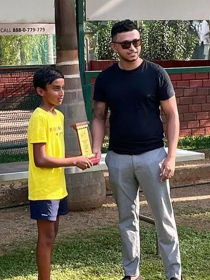 A U12 winner receives his trophy at the KSLTA State Ranking Tennis Tournament. We focus on creating a professional atmosphere to prepare young athletes for future competitions.