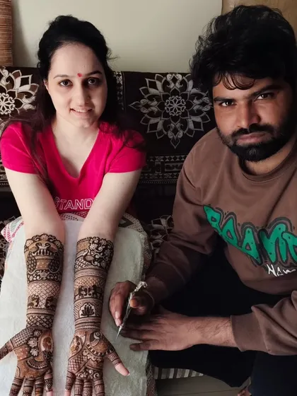 A photo with a client after finishing her beautiful full-arm mehandi. I ensure every client leaves with a smile.