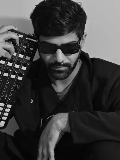 Holding my trusted Allen & Heath mixer. The gear is an extension of my creativity, allowing me to manipulate sounds and craft my sets.