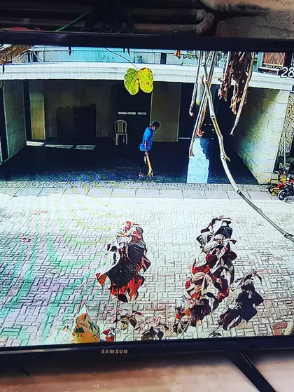 This camera captures the driveway and parking area of the residence.