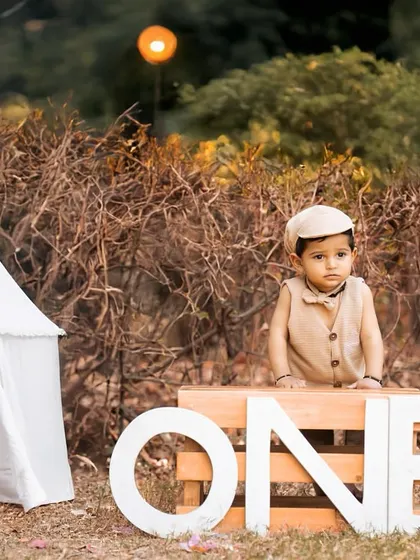 Celebrating the big 'ONE' outdoors is always special. I use natural light and rustic props like this teepee and 'ONE' sign to create a beautiful setting for your child's first birthday photoshoot in one of Jaipur's lovely parks.