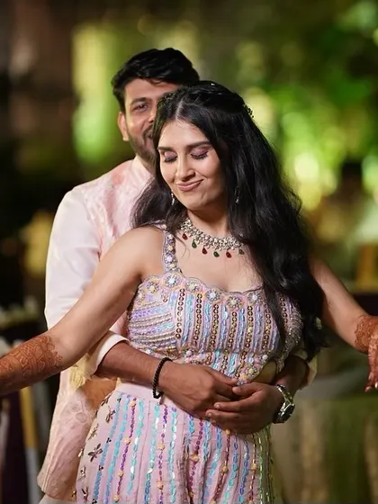 A playful, dancing moment. Her makeup is fun and fresh, perfect for a lively pre-wedding celebration.