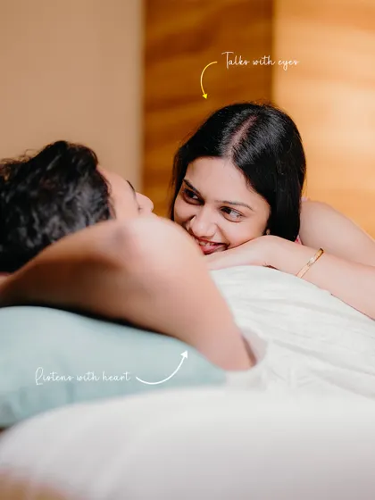 She listens with her heart, he talks with his eyes. A tender moment shared in the comfort of their bed, highlighting their deep emotional connection.