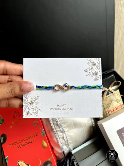 A close-up of the infinity evil eye rakhi, symbolizing an eternal bond and protection.
