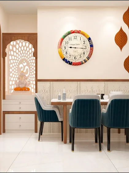 The dining area is seamlessly integrated with a beautiful pooja unit featuring jali work. The colorful clock and leaf-themed wall decor add a playful and personal touch to the space.