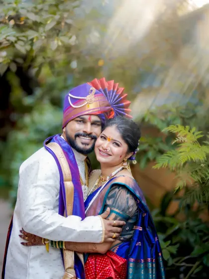 A bright, happy portrait of the couple embracing, with a beautiful sun flare effect adding a touch of magic.