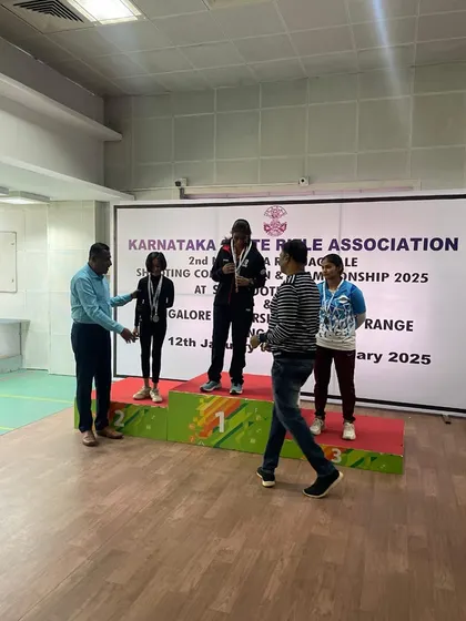 An official presents the medal to our shooter Mishika Urs during the awards ceremony at the Jagdale competition. These moments of recognition fuel our athletes' passion.