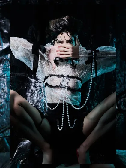 A surreal, mirrored pose from the "Chiaroscuro Dreams" editorial, creating a spider-like illusion.