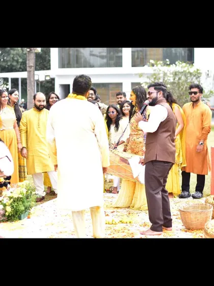 A candid side-profile shot of me in action during a Haldi ceremony.