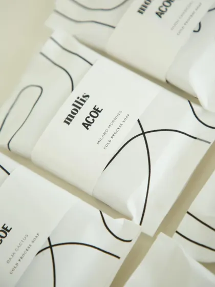 A detailed look at the custom-wrapped soaps for the Airbnb ACOE team, featuring our Milano Morning cold process soap.