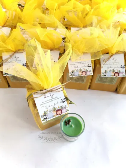 A complete, packaged jungle-themed birthday favor, showing the candle and custom tag.