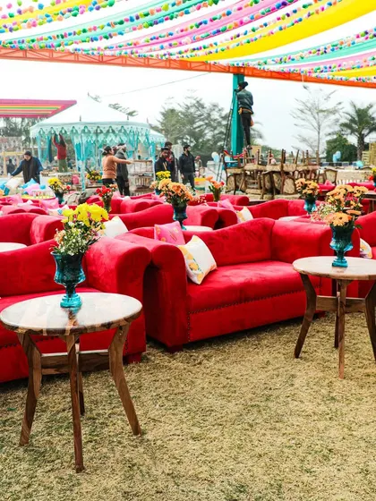 Comfortable and vibrant seating at the spice-themed Mehendi. The bright red sofas and colorful drapes created a festive and welcoming atmosphere for guests.