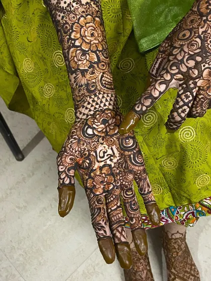 More views of Fathima's bridal henna, showing the personalized name and the stunning floral jewelry that completes the look.