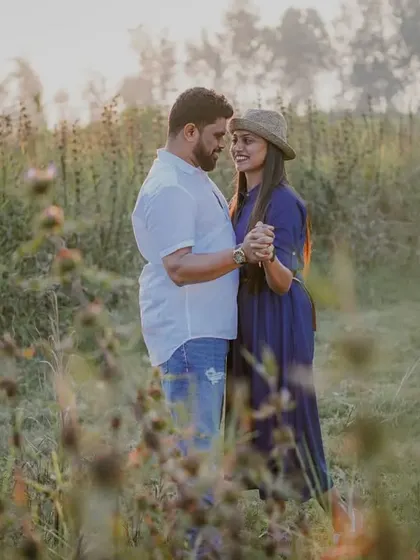 A sweet, dancing pose in a field, framed by wildflowers for a soft, romantic feel.