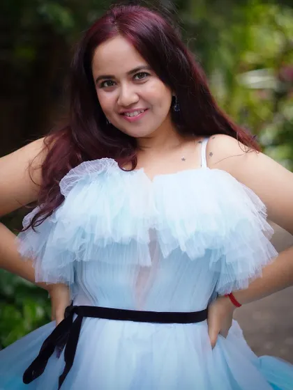 A happy client enjoying her moment in the blue ruffle gown. The dress is designed to be as fun to wear as it is beautiful.