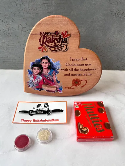 A Rakhi gift set including a heart-shaped wooden photo plaque, a custom rakhi, and chocolates.