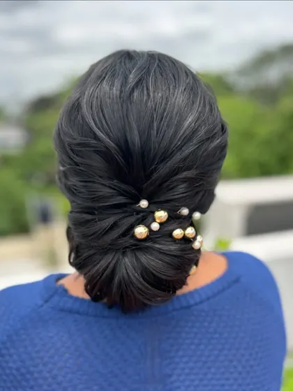 This view highlights the smooth finish and neat lines of the bun, a hallmark of professional work.