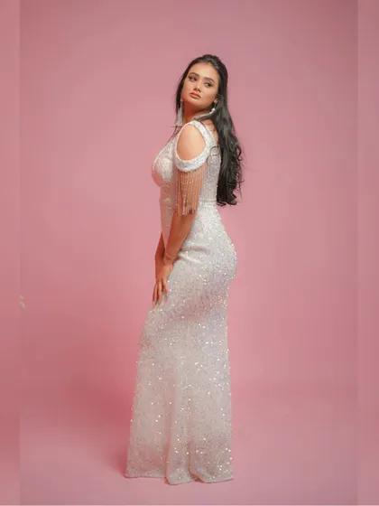 A side profile of the sequin dress, showing how it hugs the figure beautifully.