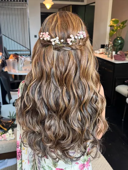 Soft, flowing waves with a delicate floral crown. This romantic hairstyle is perfect for a bride or bridesmaid looking for an ethereal vibe.