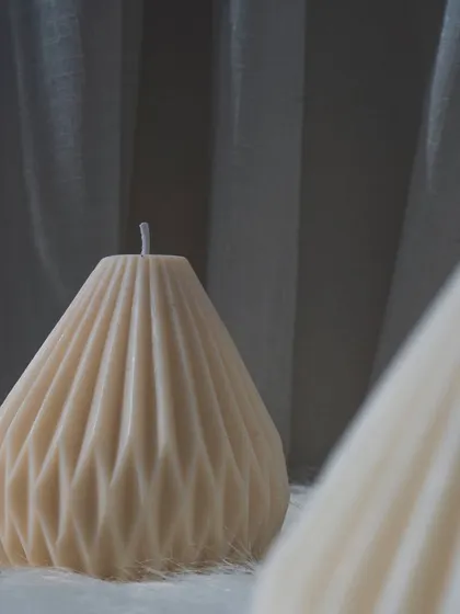 A trio of our geometric pillar candles, looking clean and modern on a white fur background.