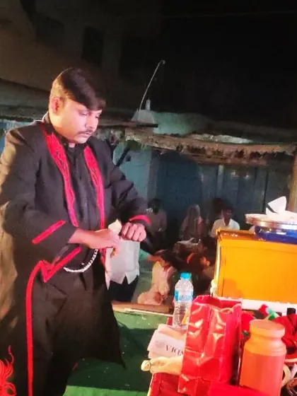 Setting up for a trick during a night show. The magic continues even after the sun goes down, creating a different and mysterious atmosphere.