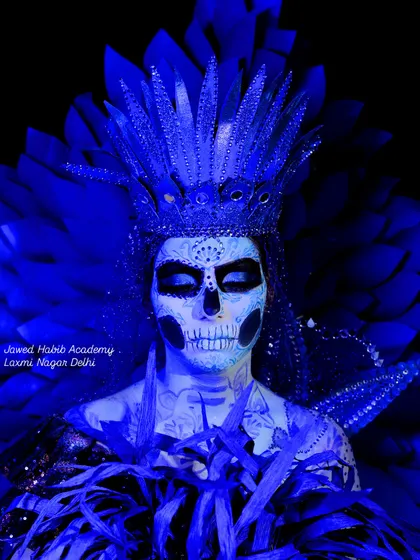 A full view of the elaborate sugar skull makeup, complete with a feathered headpiece. This shows how we guide students in creating a complete, impactful character look.
