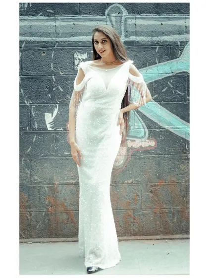 A full-length shot of the white sequin gown with fringe shoulder details. It's a sophisticated and eye-catching option for any formal event.