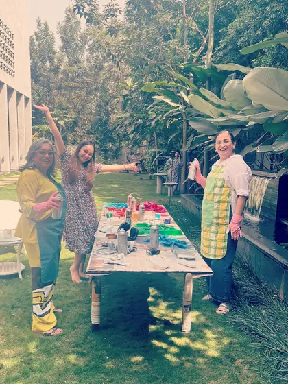 Our outdoor workshop where we cleaned and spray-painted the recycled items. It was a fun, messy, and creative process getting all the components ready for the mural.