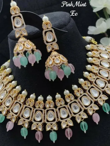 I love playing with pastel colors. This Kundan set features soft pink and mint green beads, making it a perfect choice for a daytime wedding or a reception look.