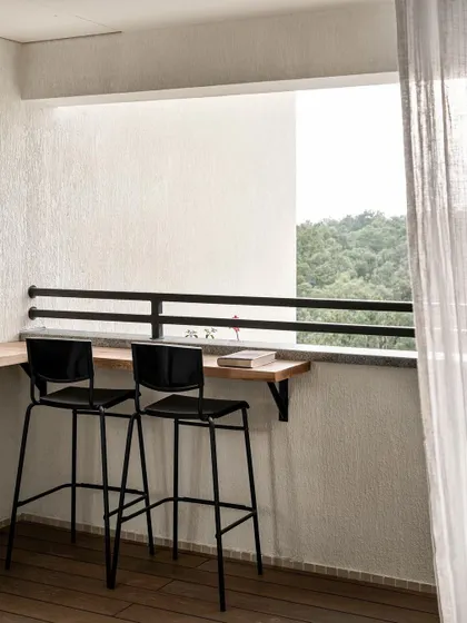 A small balcony off the dining room was transformed into a bar-height counter with a view. It's a perfect example of maximizing small outdoor spaces.