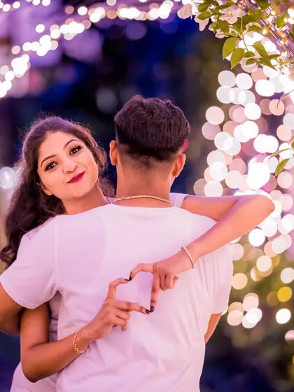A playful and creative pose within a tunnel of lights. I guide my couples to interact naturally, capturing their unique connection with a heart-shaped hand gesture.