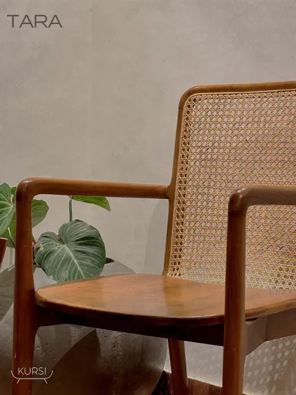 The 'Tara' armchair in a client's home, adding a touch of natural elegance to their living space. The simple lines and natural materials are exceptionally comfortable.